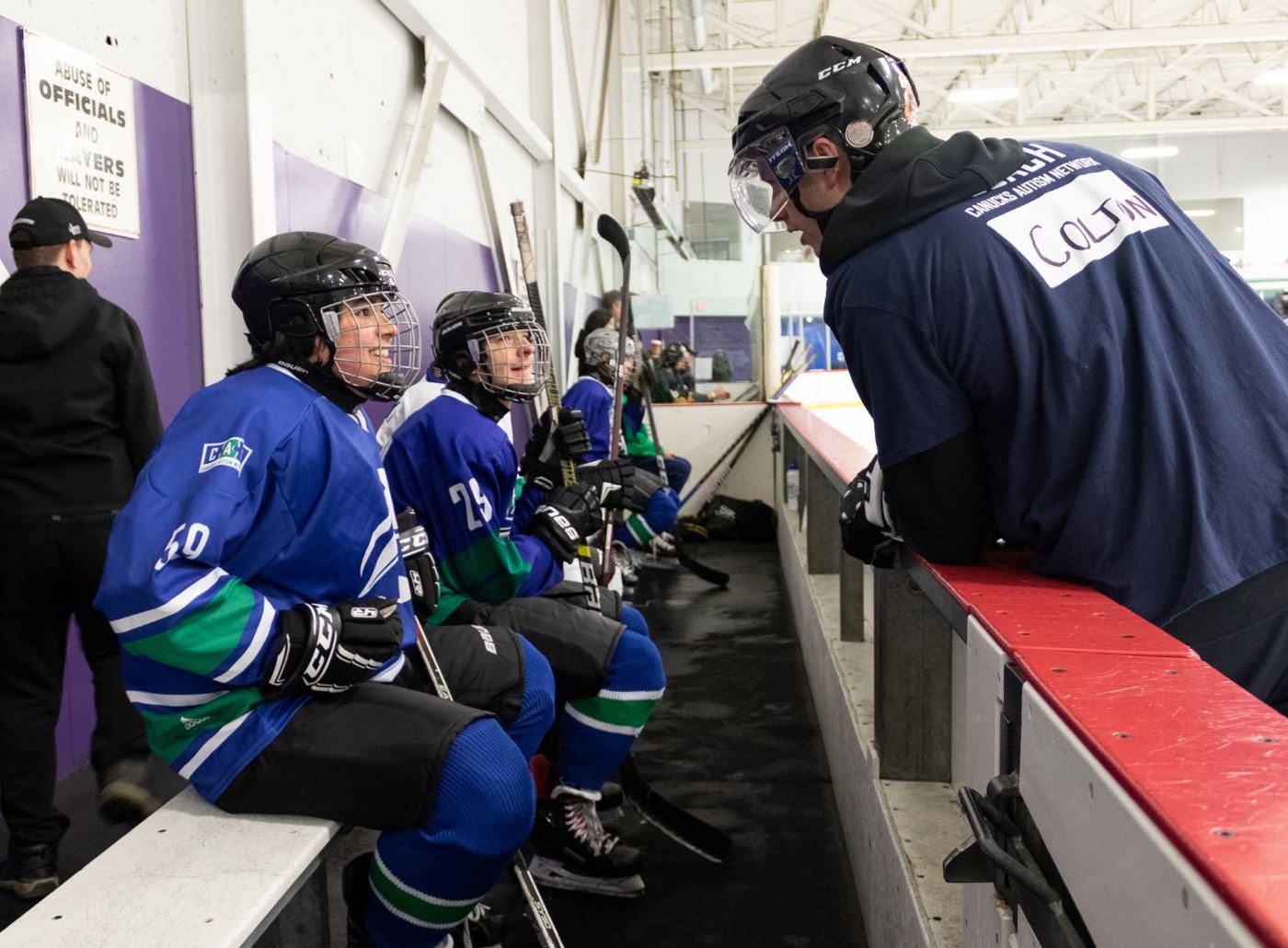 Orcas players on the bench listening to a coach